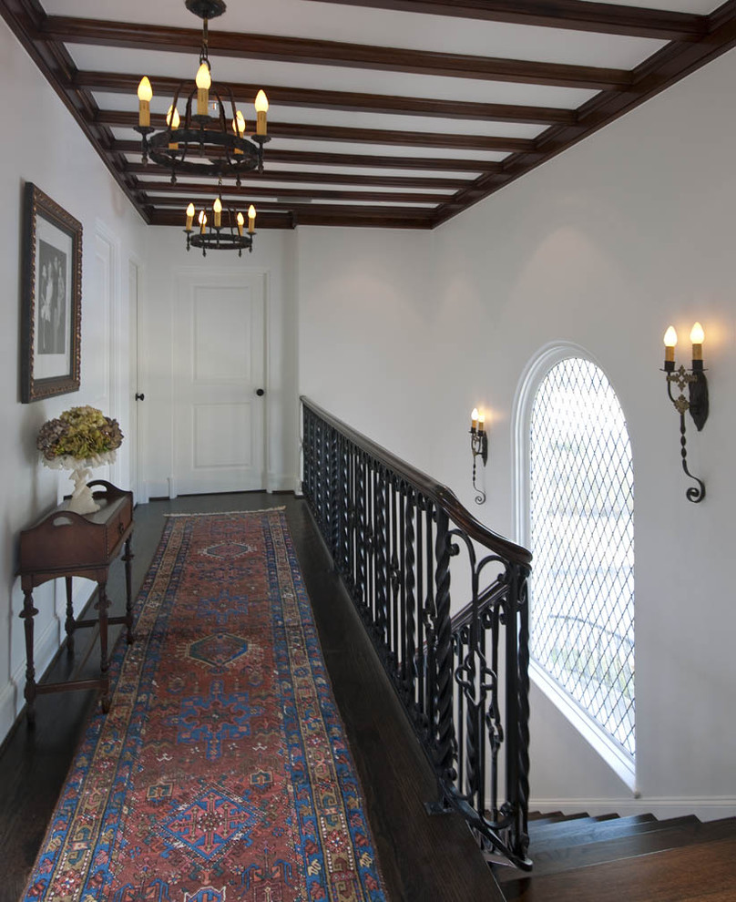 Photo of an eclectic hallway in San Diego with white walls and dark hardwood floors.
