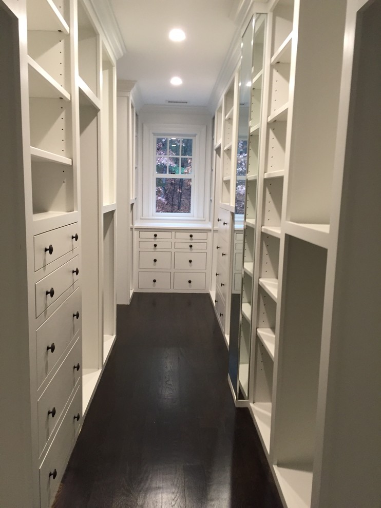Walk-in closet - large transitional gender-neutral dark wood floor walk-in closet idea in Boston with flat-panel cabinets and white cabinets
