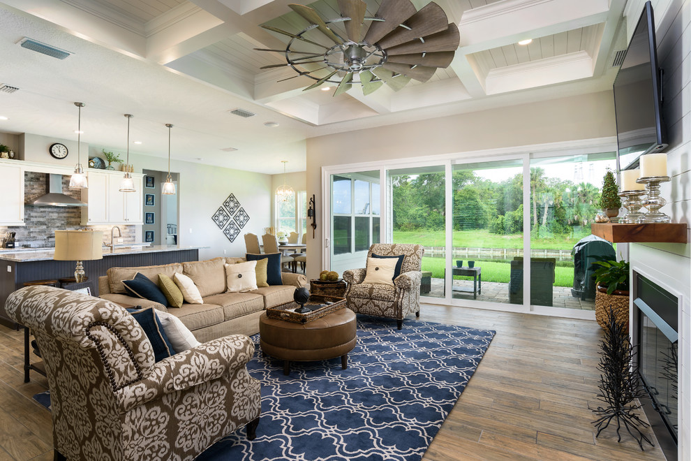 Mid-sized traditional formal open concept living room in Jacksonville with beige walls, ceramic floors, a standard fireplace, a wood fireplace surround, a wall-mounted tv and multi-coloured floor.