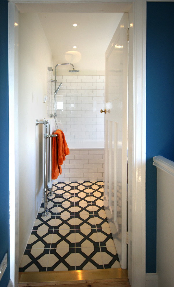 Design ideas for a small eclectic master bathroom with a drop-in tub, a shower/bathtub combo, white tile, porcelain tile, ceramic floors, blue floor and a hinged shower door.