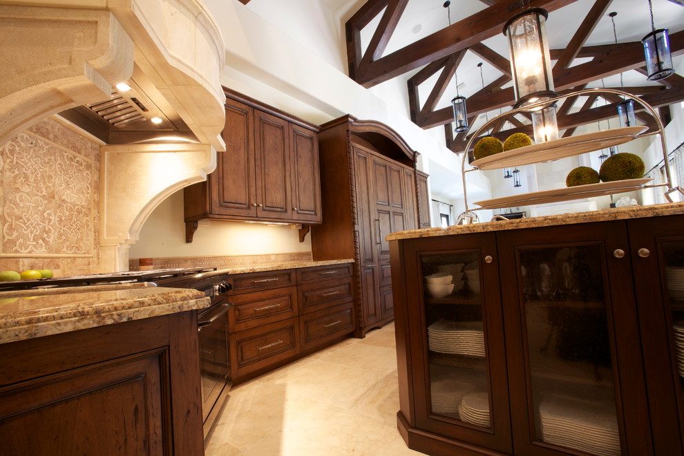 Inspiration for a mid-sized traditional kitchen in Houston with raised-panel cabinets, medium wood cabinets, granite benchtops, beige splashback, panelled appliances, travertine floors and with island.