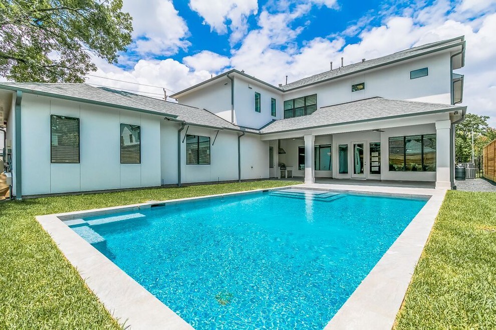Inspiration for a transitional backyard concrete paver and rectangular lap pool remodel in Houston