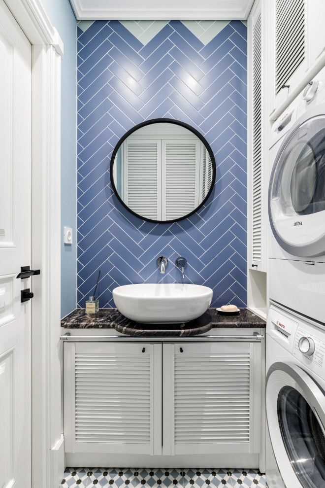 Design ideas for a small traditional powder room in Saint Petersburg with white cabinets, blue tile, ceramic tile, a vessel sink, black benchtops, louvered cabinets, blue walls, multi-coloured floor and a built-in vanity.