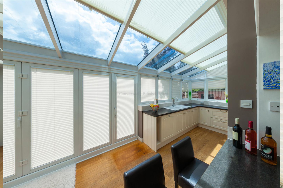 This is an example of a mid-sized contemporary sunroom in Surrey.