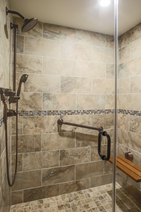 Large transitional bathroom in New York with beige tile, porcelain tile and porcelain floors.
