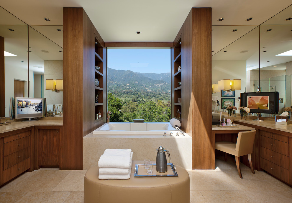 This is an example of a large mediterranean master bathroom in Santa Barbara with a drop-in tub, ceramic floors, beige floor, beige benchtops, flat-panel cabinets and medium wood cabinets.