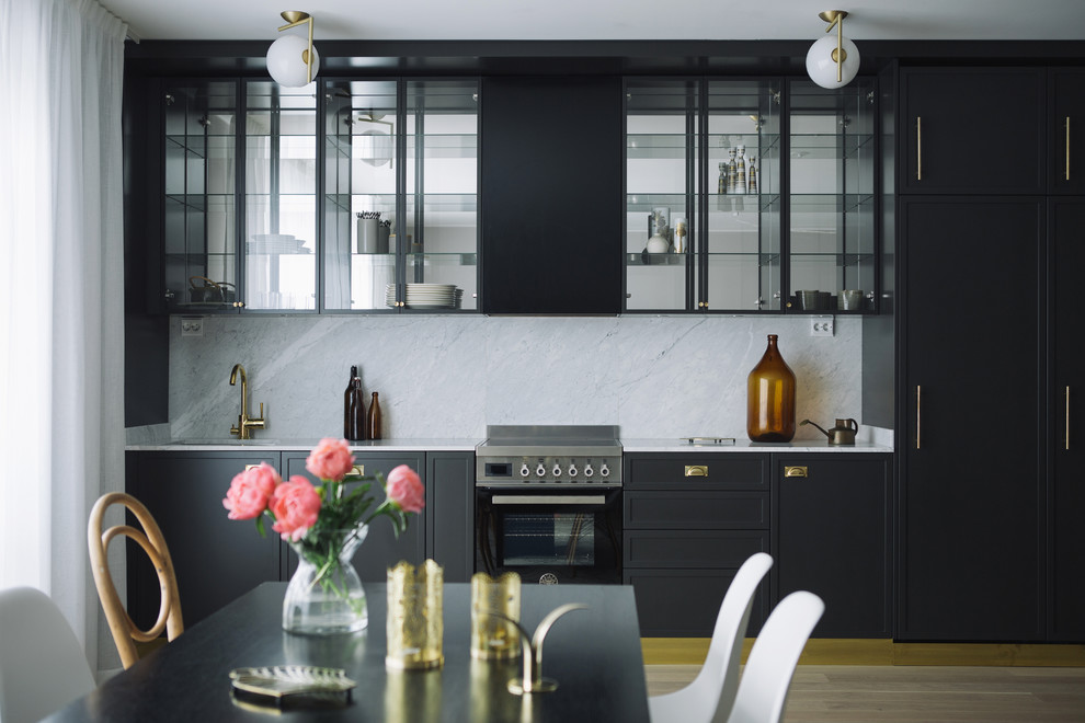 Design ideas for a modern single-wall kitchen in Stockholm with a drop-in sink, recessed-panel cabinets, blue cabinets, marble benchtops, stainless steel appliances, medium hardwood floors and no island.