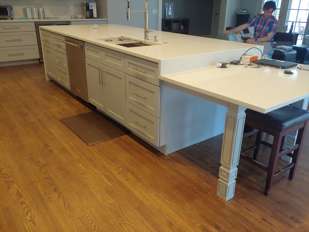 Large transitional single-wall light wood floor eat-in kitchen photo with a single-bowl sink, shaker cabinets, gray cabinets, quartzite countertops, stainless steel appliances, an island and white countertops