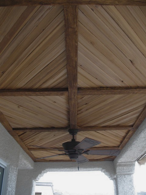 Covered Patio With Faux Wood Beam And Plank Ceiling Rustic