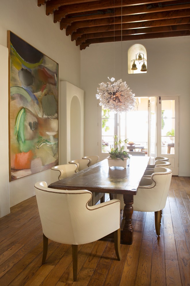 Inspiration for a mediterranean dining room in Portland with beige walls and dark hardwood floors.