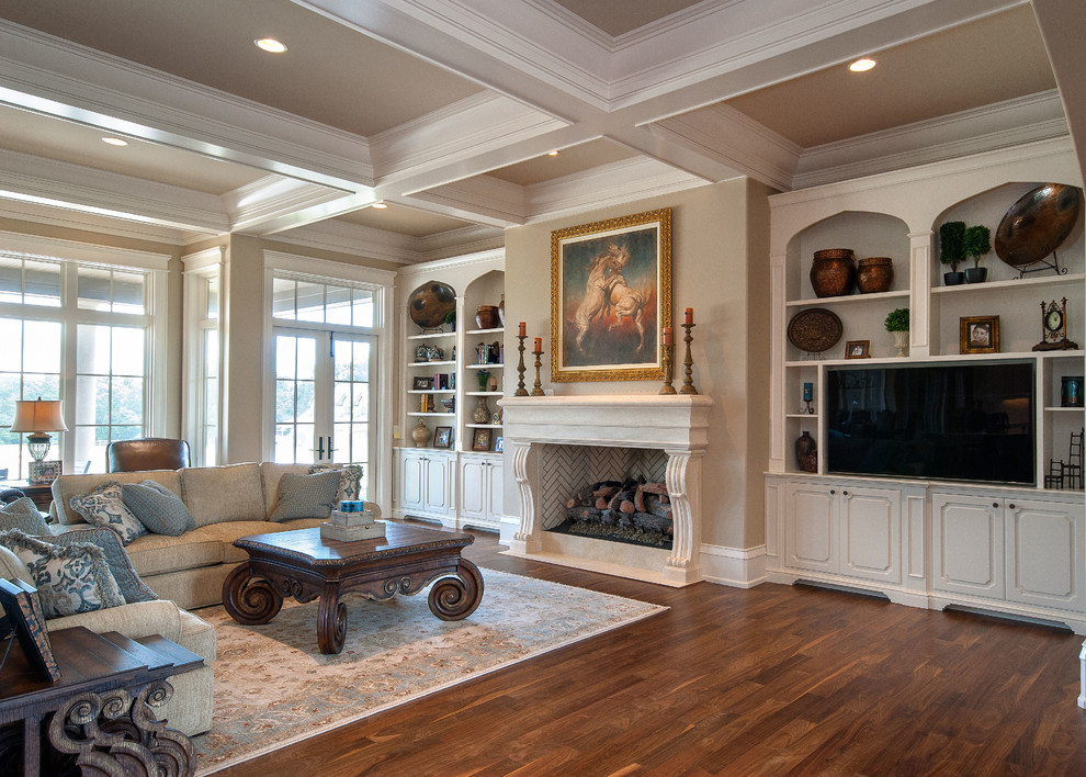 This is an example of an expansive traditional open concept living room in Other with beige walls, medium hardwood floors, a standard fireplace, a stone fireplace surround and a built-in media wall.