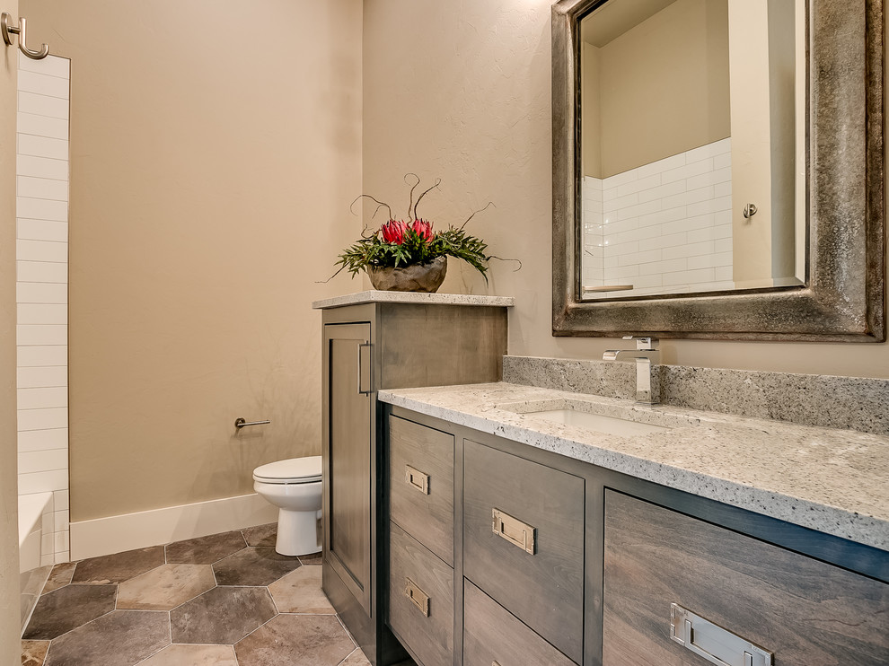 Photo of a transitional bathroom in Oklahoma City with flat-panel cabinets, grey cabinets, ceramic floors and granite benchtops.