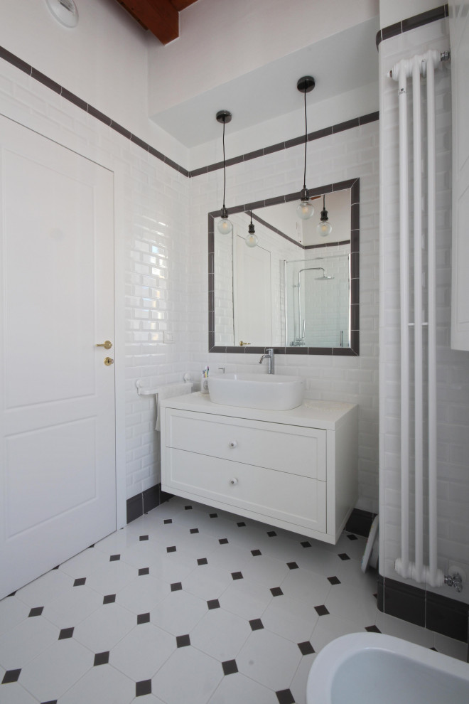 Design ideas for a mid-sized country 3/4 bathroom in Milan with recessed-panel cabinets, white cabinets, a corner shower, a two-piece toilet, black and white tile, subway tile, white walls, mosaic tile floors, a vessel sink, wood benchtops, multi-coloured floor, a sliding shower screen, white benchtops, a single vanity, a freestanding vanity, exposed beam and brick walls.