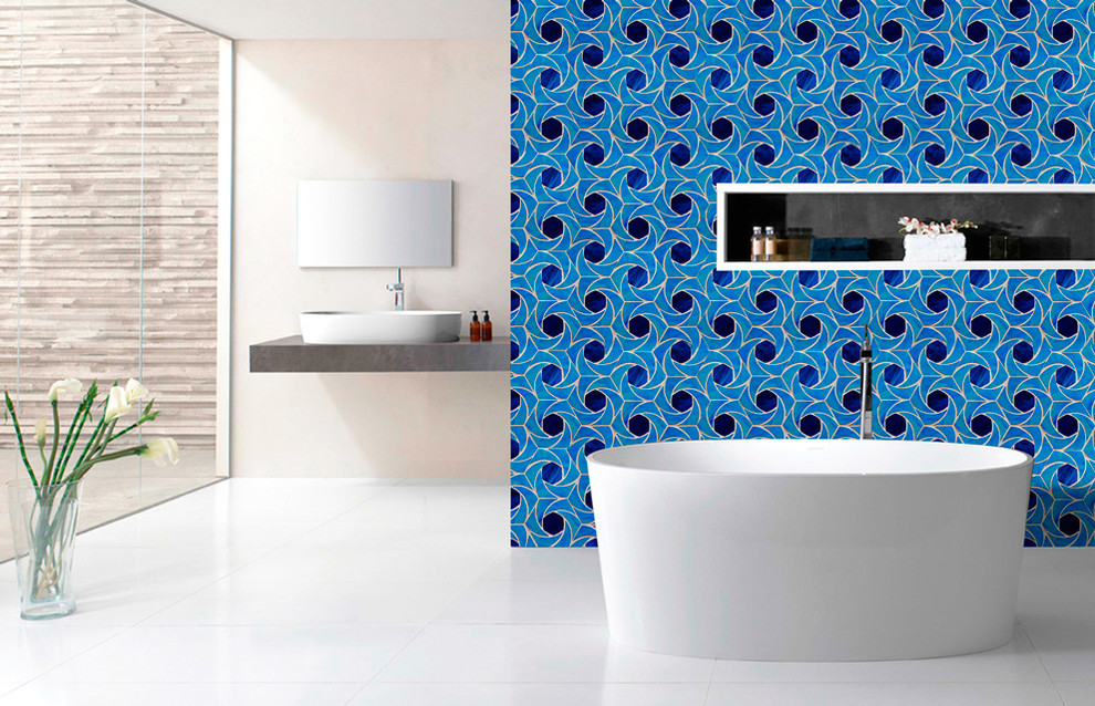 This is an example of a mid-sized modern master bathroom in Gold Coast - Tweed with blue walls, mosaic tile, beaded inset cabinets, white cabinets, a drop-in tub, a corner shower, a one-piece toilet, green tile, porcelain floors, a drop-in sink, solid surface benchtops, white floor, an open shower and grey benchtops.