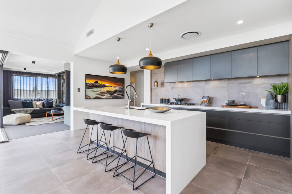 Inspiration for a contemporary galley open plan kitchen in Perth with an undermount sink, flat-panel cabinets, grey cabinets, grey splashback, with island, grey floor and white benchtop.