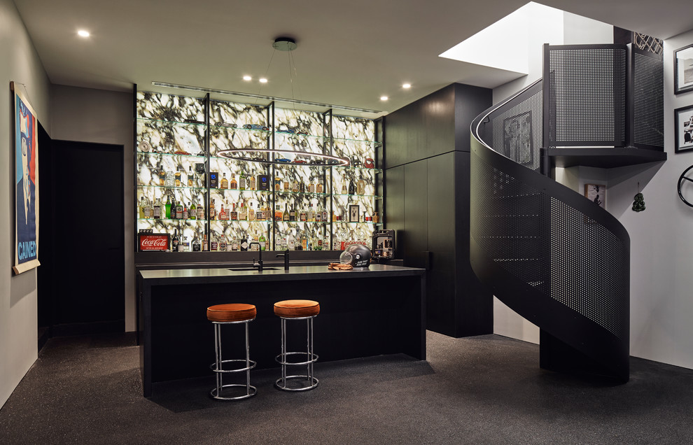 Photo of a mid-sized contemporary l-shaped seated home bar in Melbourne with an undermount sink, black cabinets, granite benchtops, multi-coloured splashback, stone slab splashback, black floor, black benchtop and flat-panel cabinets.