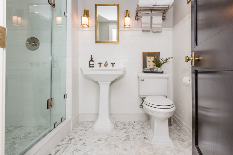 Design ideas for a small transitional 3/4 bathroom in DC Metro with open cabinets, a corner shower, a two-piece toilet, white tile, stone tile, white walls, marble floors and a pedestal sink.