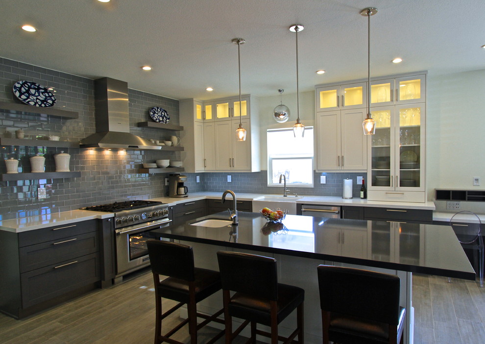 Transitional porcelain tile kitchen photo in Orange County with glass tile backsplash and an island
