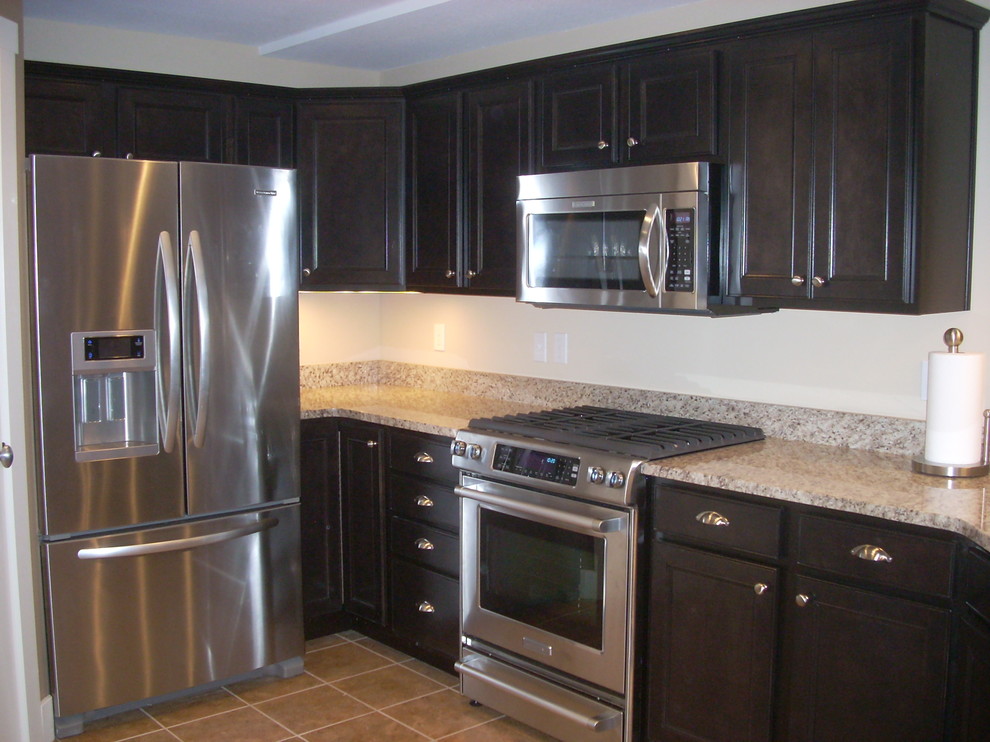 Mid-sized single-wall kitchen photo with granite countertops, beige backsplash, stainless steel appliances and a double-bowl sink