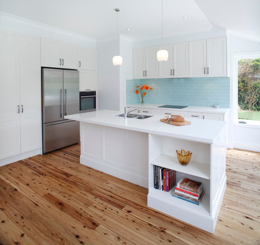 Inspiration for a large transitional l-shaped eat-in kitchen in Sydney with an undermount sink, shaker cabinets, white cabinets, quartz benchtops, blue splashback, ceramic splashback, stainless steel appliances, bamboo floors and with island.