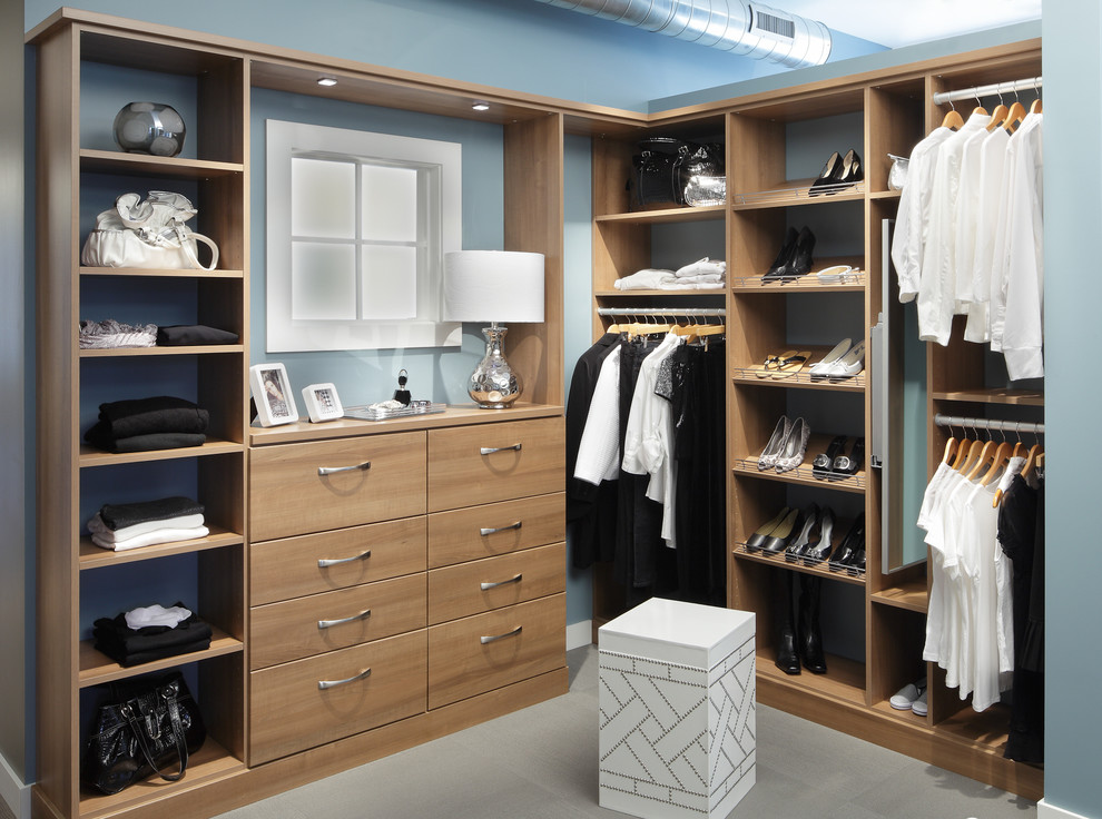 Inspiration for a mid-sized timeless gender-neutral carpeted and gray floor walk-in closet remodel in New Orleans with open cabinets and medium tone wood cabinets