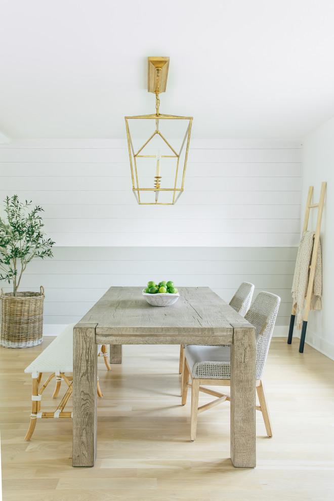 Inspiration for a large beach style separate dining room in Other with white walls, light hardwood floors, brown floor and planked wall panelling.