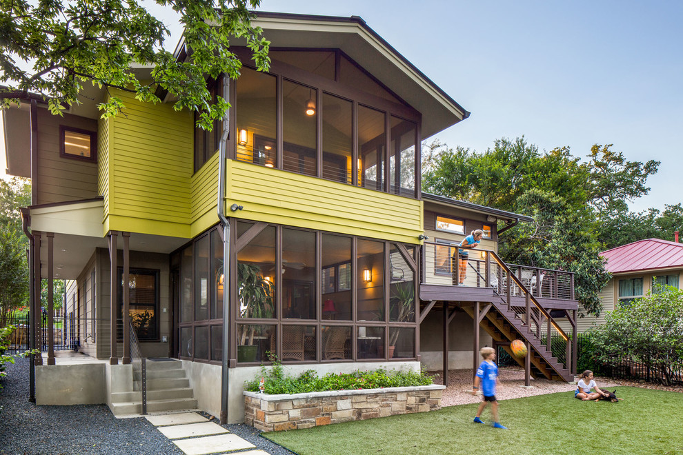 Inspiration for a large contemporary split-level green exterior in Austin with concrete fiberboard siding and a gable roof.