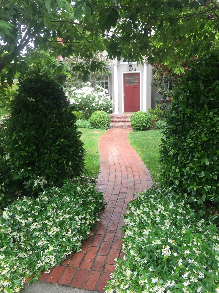 Photo of a large traditional partial sun front yard brick landscaping in San Francisco.