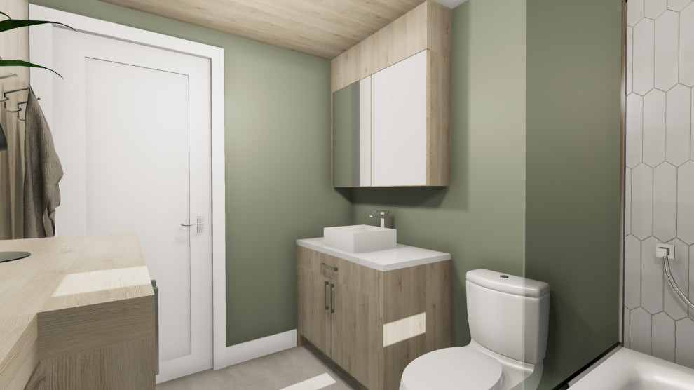 Inredning av ett minimalistiskt litet vit vitt en-suite badrum, med släta luckor, skåp i ljust trä, ett badkar i en alkov, en dusch/badkar-kombination, en toalettstol med separat cisternkåpa, vit kakel, porslinskakel, gröna väggar, klinkergolv i porslin, ett fristående handfat, bänkskiva i kvartsit och grått golv