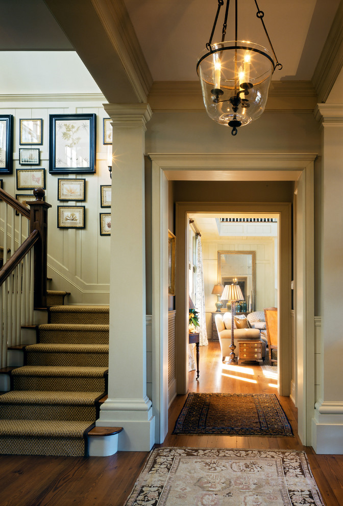 This is an example of a traditional foyer in Charleston with dark hardwood floors.