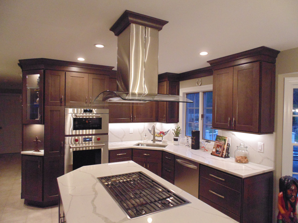 Mid-sized transitional u-shaped ceramic tile and beige floor eat-in kitchen photo with an undermount sink, recessed-panel cabinets, dark wood cabinets, quartz countertops, white backsplash, stone slab backsplash, stainless steel appliances, an island and white countertops