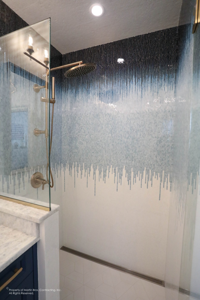 Inspiration for a mid-sized transitional master porcelain tile, white floor and single-sink walk-in shower remodel with recessed-panel cabinets, blue cabinets, a two-piece toilet, white walls, an undermount sink, quartzite countertops, a hinged shower door, a niche and a built-in vanity