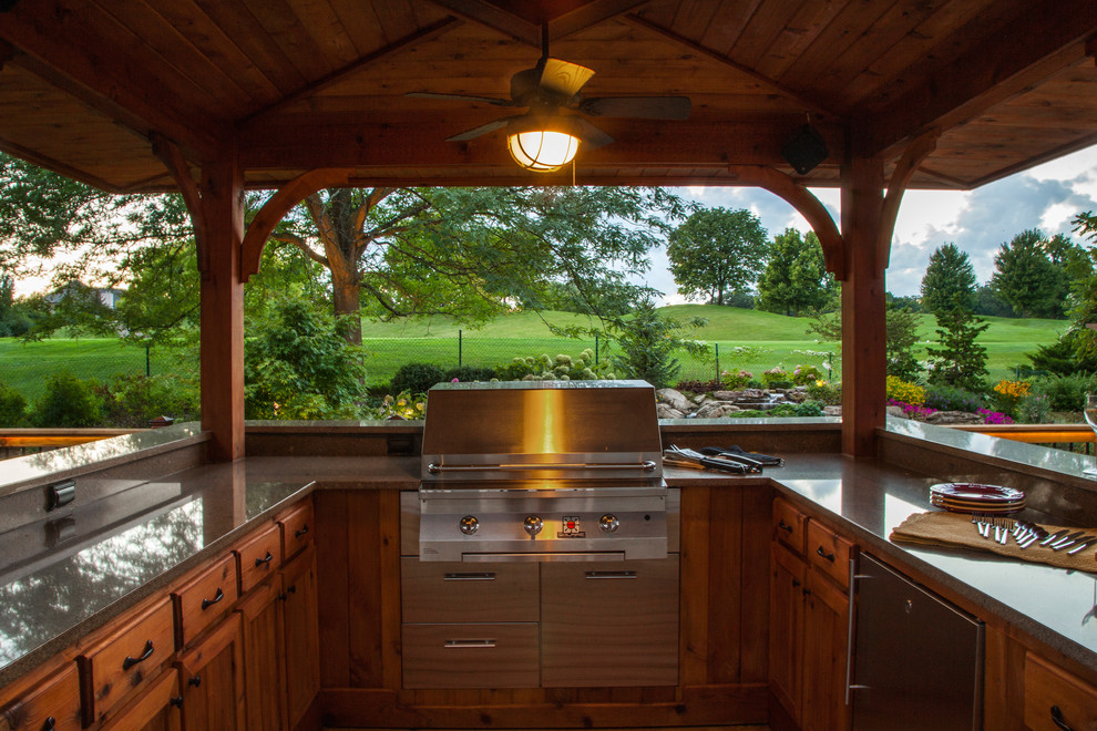 Inspiration for a timeless backyard outdoor kitchen deck remodel in Chicago with a gazebo and decking