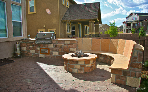 Inspiration for a large transitional backyard stone patio remodel in Denver with no cover