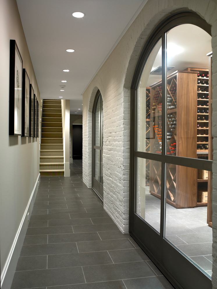 Inspiration for a large contemporary wine cellar in Philadelphia with limestone floors, diamond bins and grey floor.