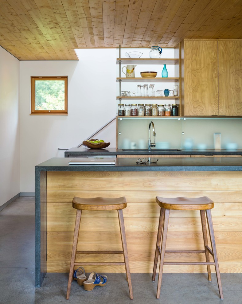 Small contemporary galley eat-in kitchen in Other with flat-panel cabinets, medium wood cabinets, with island, concrete benchtops, stainless steel appliances, concrete floors, grey floor and grey benchtop.