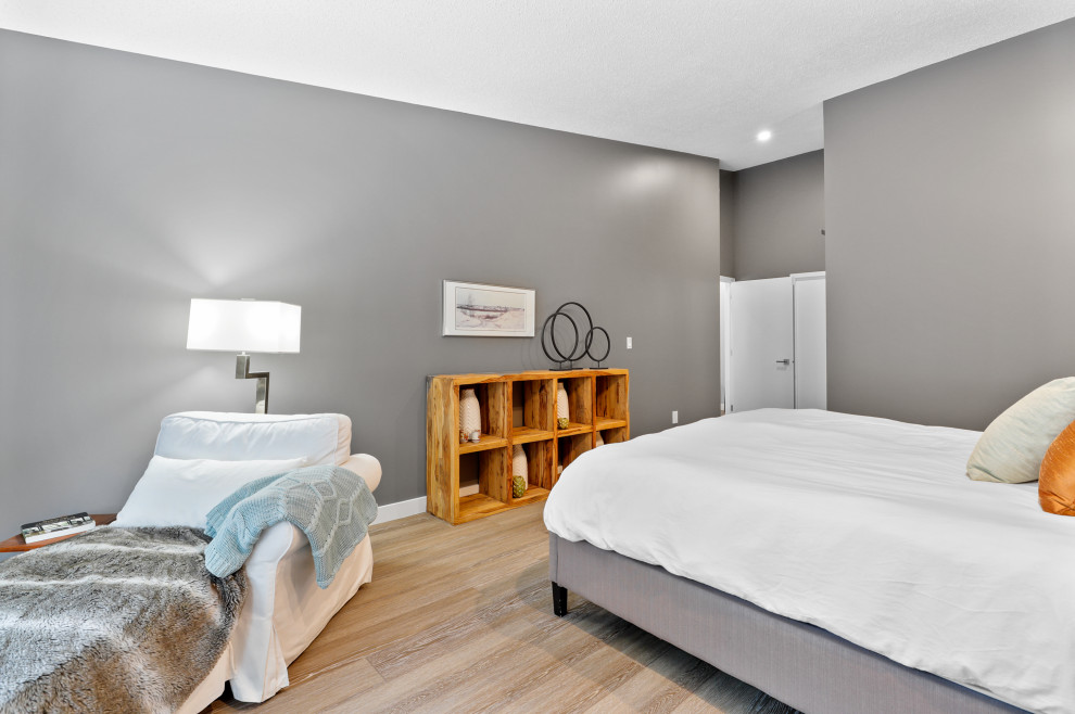 Mid-sized trendy master light wood floor and beige floor bedroom photo in Calgary with gray walls and no fireplace