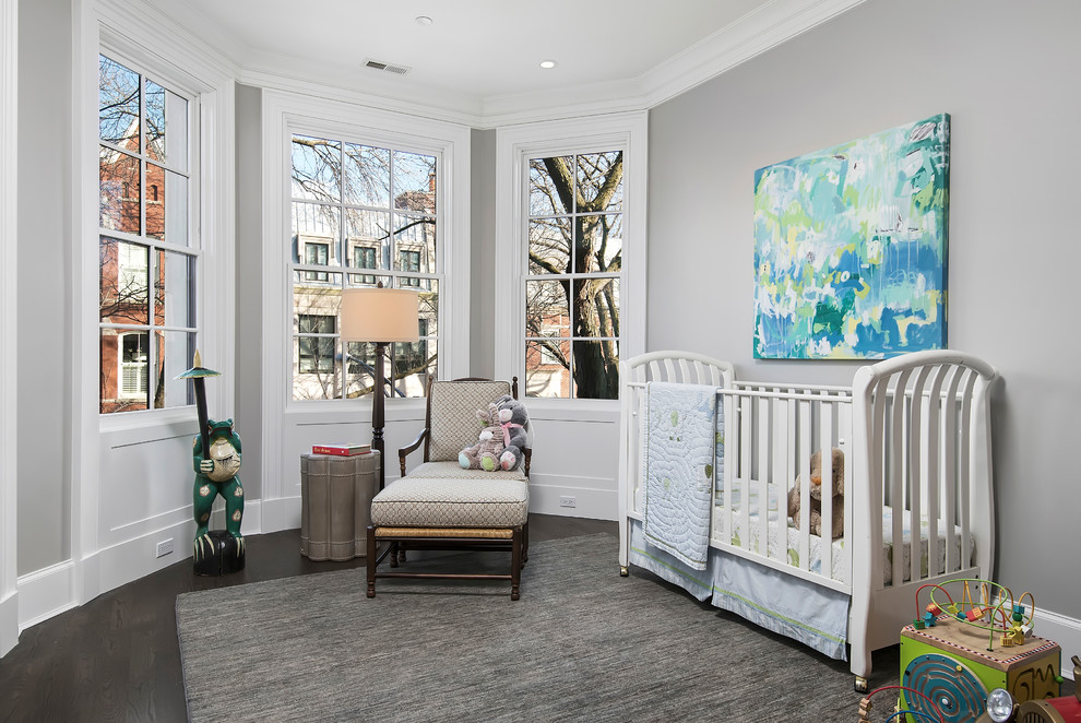 This is an example of a traditional gender-neutral nursery in Chicago with grey walls, dark hardwood floors and brown floor.