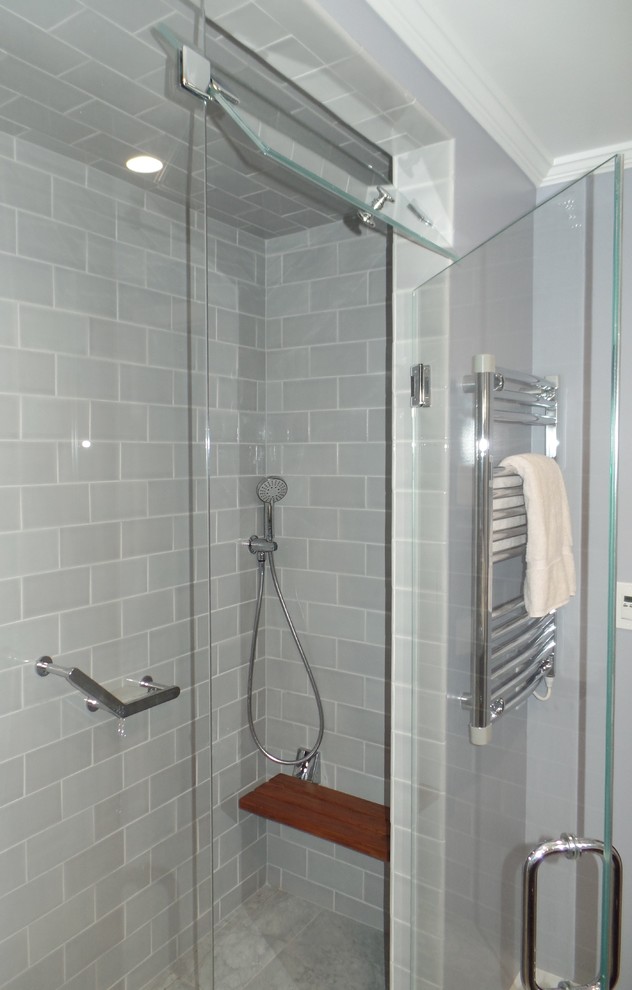 Inspiration for a mid-sized transitional master gray tile and ceramic tile porcelain tile and gray floor walk-in shower remodel with recessed-panel cabinets, dark wood cabinets, a bidet, gray walls, an undermount sink, quartz countertops, a hinged shower door and white countertops