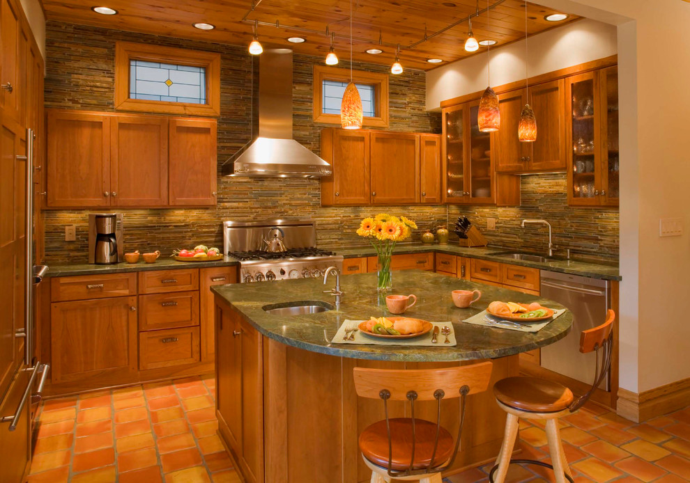 Inspiration for a mid-sized transitional u-shaped terra-cotta tile eat-in kitchen remodel in Chicago with an undermount sink, shaker cabinets, medium tone wood cabinets, green backsplash, stainless steel appliances, an island, granite countertops and stone tile backsplash