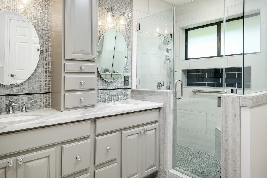 Inspiration for a large transitional master gray tile and mosaic tile laminate floor and beige floor corner shower remodel with raised-panel cabinets, gray cabinets, beige walls, an undermount sink, quartzite countertops, a hinged shower door and white countertops