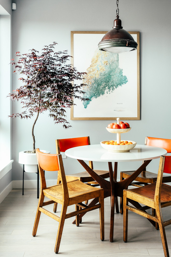 Contemporary dining room in Portland Maine with grey walls and light hardwood floors.