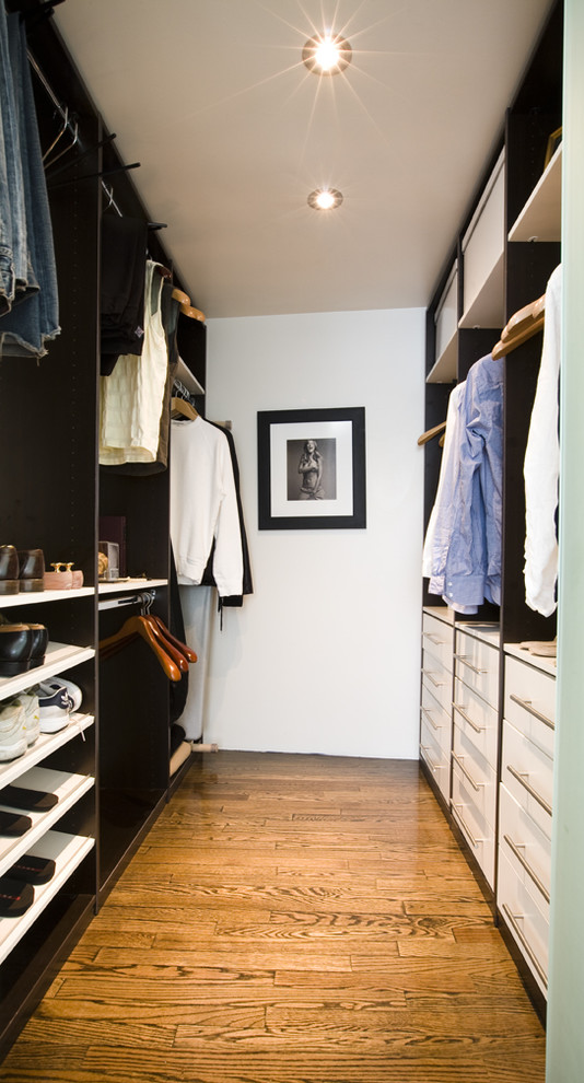 Photo of a mid-sized contemporary men's walk-in wardrobe in Miami with white cabinets, flat-panel cabinets and dark hardwood floors.