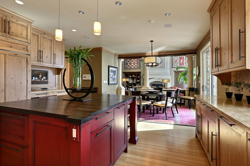 Inspiration for a traditional eat-in kitchen in Denver with recessed-panel cabinets, light wood cabinets and panelled appliances.