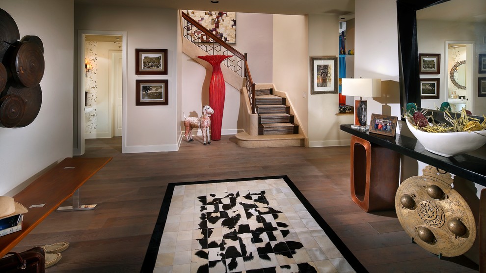 Large transitional medium tone wood floor and brown floor foyer photo in Orange County