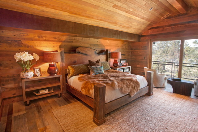 Inspiration for a large rustic master light wood floor home design remodel with brown walls and a stone fireplace