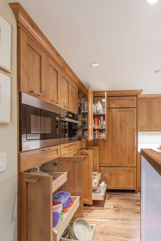 Example of a tuscan kitchen design in Baltimore with white backsplash and stainless steel appliances