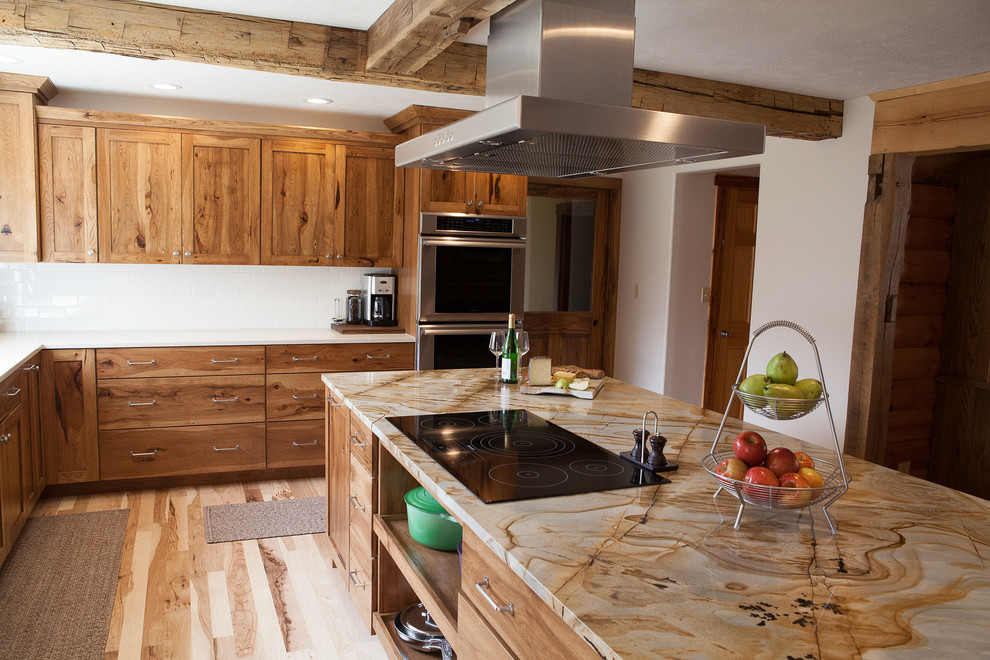 Inspiration for a mid-sized rustic l-shaped light wood floor eat-in kitchen remodel in Indianapolis with a single-bowl sink, flat-panel cabinets, medium tone wood cabinets, quartzite countertops, white backsplash, subway tile backsplash, stainless steel appliances, white walls, an island and multicolored countertops