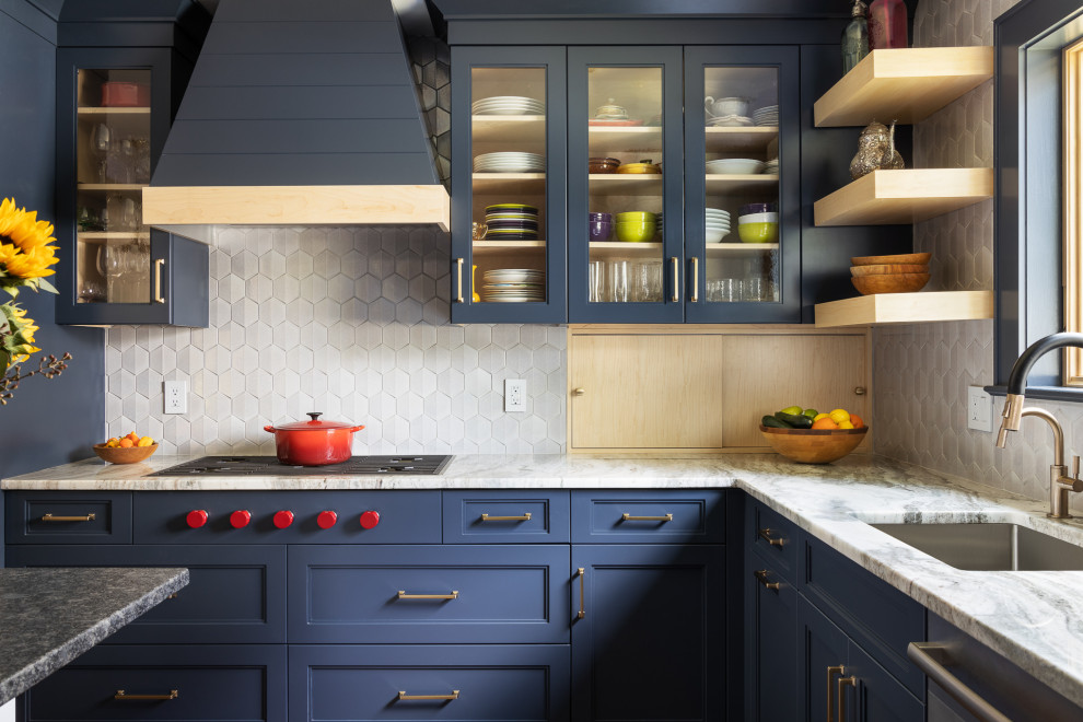 Inspiration for a transitional l-shaped separate kitchen in New York with an undermount sink, recessed-panel cabinets, blue cabinets, quartzite benchtops, metallic splashback, glass tile splashback, stainless steel appliances, medium hardwood floors, with island, brown floor and multi-coloured benchtop.