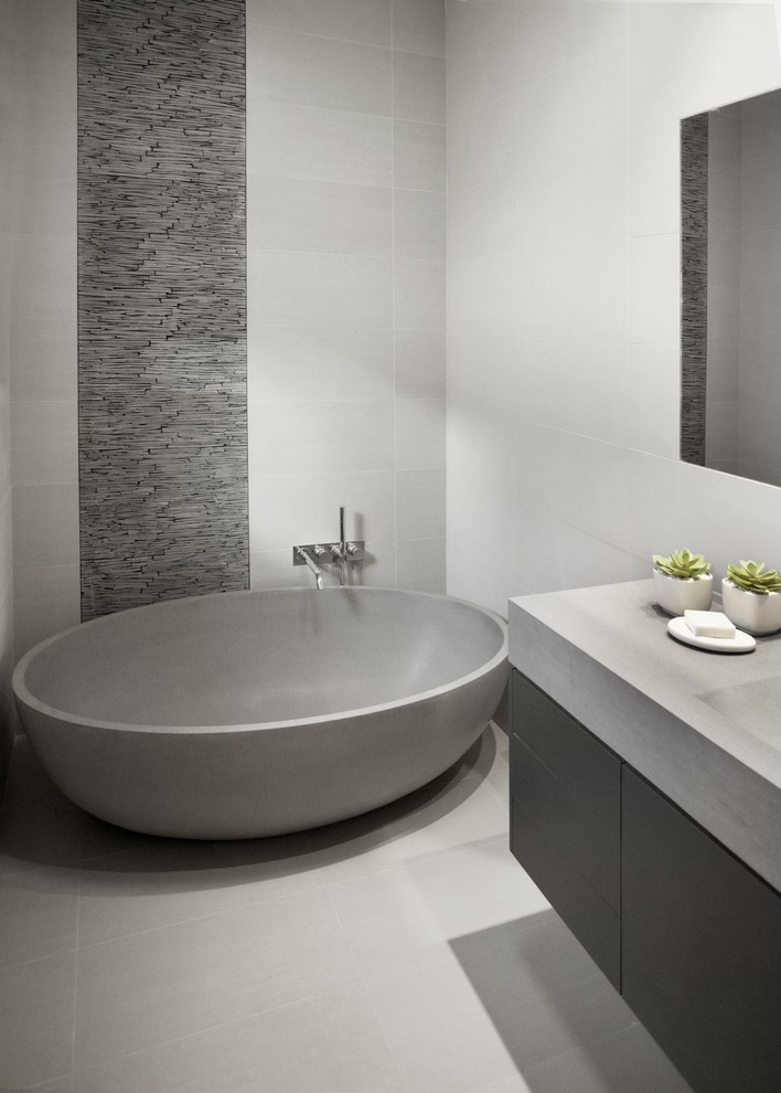 Inspiration for a small contemporary master bathroom in Melbourne with a freestanding tub, gray tile, ceramic tile and ceramic floors.